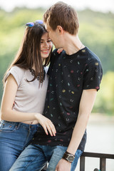 Fototapeta premium Caucasian couple taking a walk in the park. Lifestyle and relationship. Young inlove boyfriend and girlfriend
