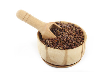 Aframomum melegueta in wooden cup isolated