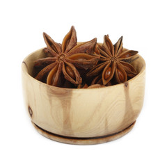 star anise (badian) in wooden cup isolated