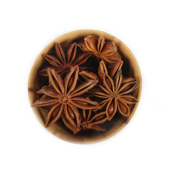 star anise (badian) in wooden cup isolated