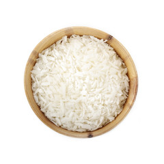 Dried grated coconut in wooden cup isolated on white background