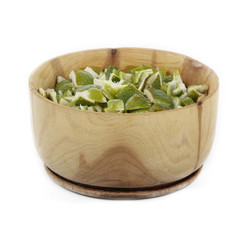 dried rind of lime in wooden cup isolated