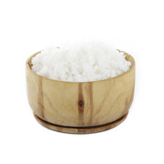 Dried grated coconut in wooden cup isolated on white background