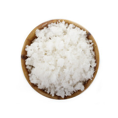 Dried grated coconut in wooden cup isolated on white background