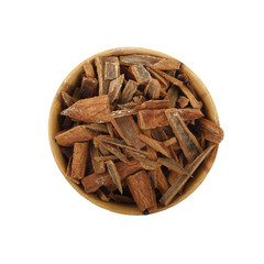 cinnamon (cassia) in wooden cup isolated on white background