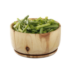 green garlic in wooden cup isolated