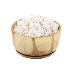 Dried grated coconut in wooden cup isolated on white background