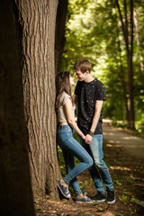 Young couple taking a walk in the forest. Lifestyle and relationship. Young inlove boyfriend and girlfriend