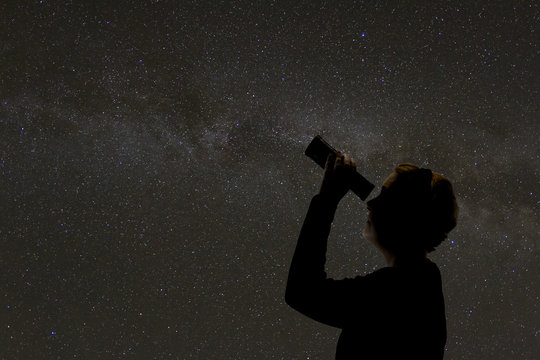 Silhouette Of Woman Looking At Stars