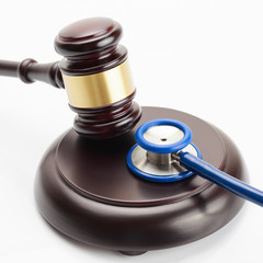 Close up shot of a wooden judge gavel and a stethoscope