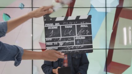  Make up artist & floor manager preparing tv presenter before he goes on air