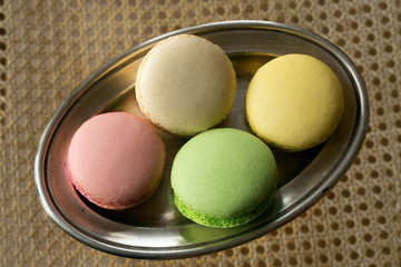 Multicolored cakes on a silver plate