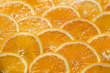 Bright orange background from slices of juicy Orange. Healthy food, background.