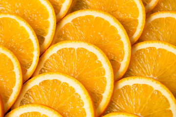 Bright orange background from slices of juicy Orange. Healthy food, background.