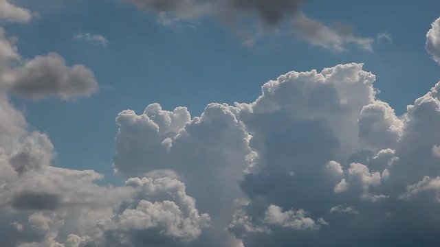 Timelapse of cumulus clouds forming on a clear blue sky