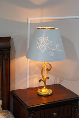 Lamp with a lampshade in the classic style in the bedroom. Interior