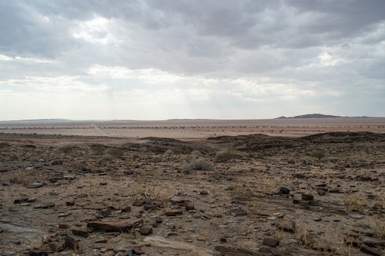 Stony Desert with Mountains and Dirt Road between Walvis Bay and Solitaire in Namibia