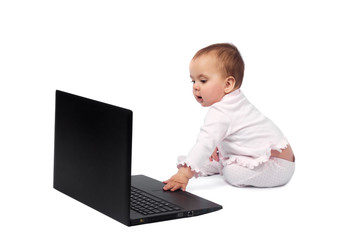 Smiling baby and laptop isolated on white