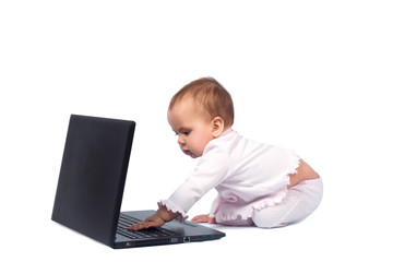 Smiling baby and laptop isolated on white