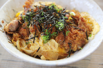 Japanese deep fried pork with egg on rice , Katsudon on wood background