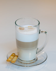 Cup with latte and salted stics.