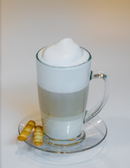 Cup with latte and salted stics.
