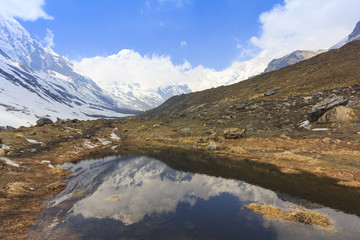 Himalaya Annapurna snow mountain range with reflection on pond, Nepal