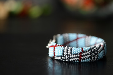 Blue beaded bracelet on a dark background