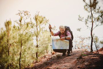 Young hipster hiking in in the mountains.