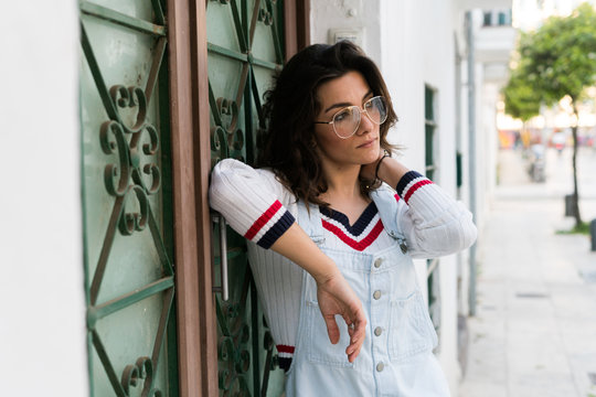 Young woman leaning against door