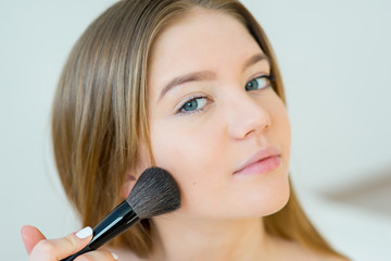 Woman applying makeup