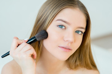 Woman applying makeup