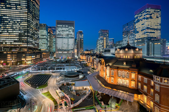 Tokyo railway station and Tokyo highrise building at twilight time in Tokyo, Japan.