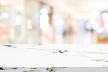 Empty white marble table over blur store background, product and food display montage