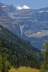 Mountain landscape of French Pyrenees with picturesque valley and waterfall Gavernie