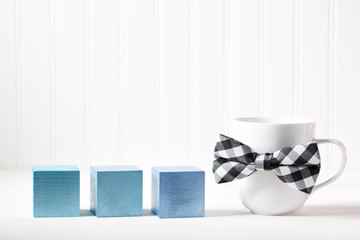 Mug with bowtie and blue wooden blocks