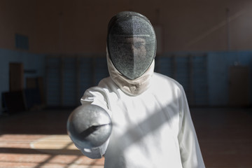 the fencer prepares for competitions. fencing coach. fencing sport motivation. mask and sword