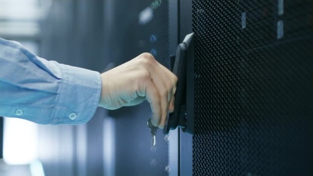  In Data Center Man Closes Server Rack Cabinet Doors and Leaves. Shot on RED EPIC-W 8K Helium Cinema Camera.