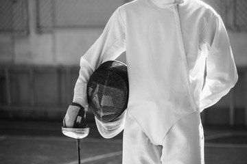 the fencer prepares for competitions. fencing coach. fencing sport motivation. mask and sword
