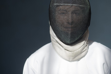 the fencer prepares for competitions. fencing coach. fencing sport motivation. mask and sword