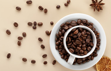 Coffee beans and white cup of coffee