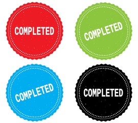 COMPLETED text, on round wavy border stamp badge.