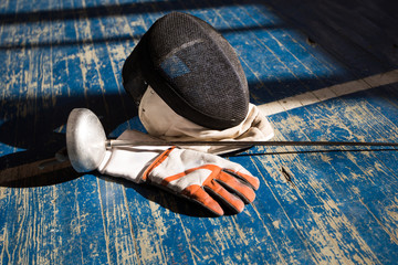 the fencer prepares for competitions. fencing coach. fencing sport motivation. mask and sword