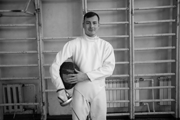 the fencer prepares for competitions. fencing coach. fencing sport motivation. mask and sword