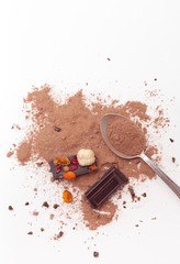 Chocolate pieces with nuts and berries on white