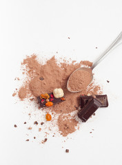 Chocolate pieces with nuts and berries on white