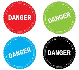 DANGER text, on round wavy border stamp badge.