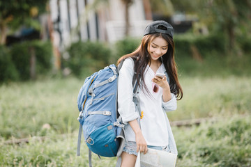 Woman using a smart phone in a sunny summer day,travel concept