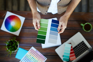 Color swatches in hands of interior-designer