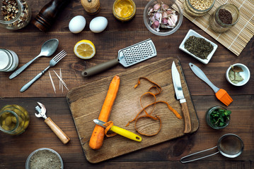 Fototapeta na wymiar Carrot on wooden kitchen table with vegetables cooking ingredients 